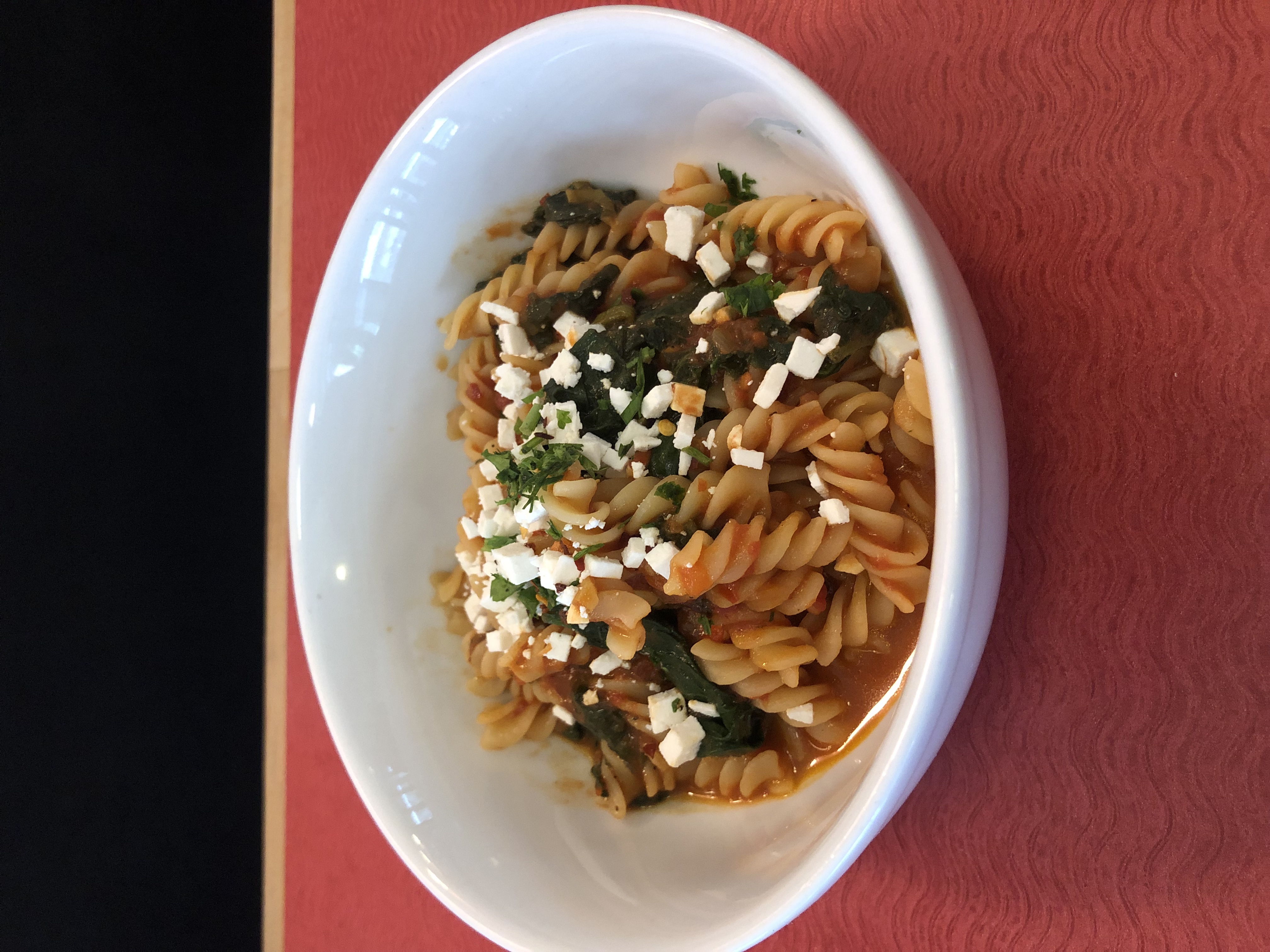 Fusilli  with sauteed spinach, spicy tomatoes sauce and ricotta cheese.