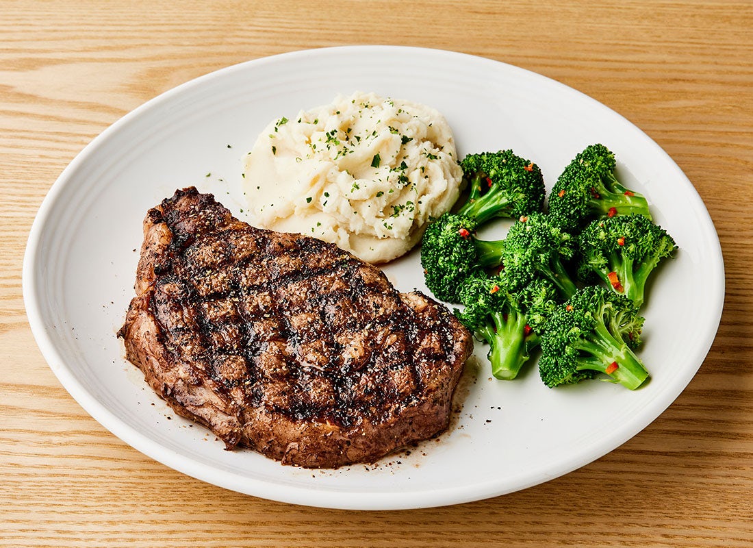 Order NEW! Tuscan-Grilled Ribeye* 16oz food online from Carrabba's Italian Grill store, Murrells Inlet on bringmethat.com
