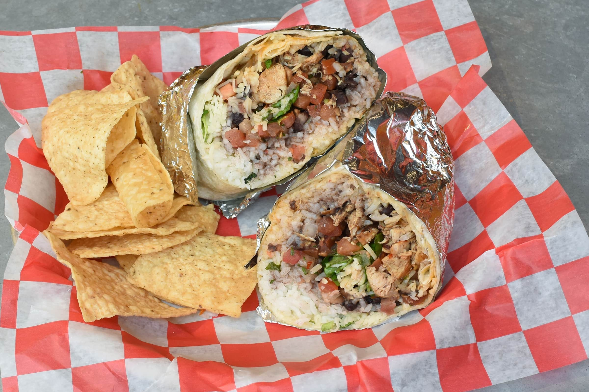 Massive burritos with customizable fillings and signature local queso