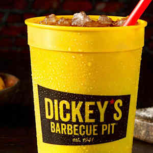 A yellow branded cup filled with ice and a drink.