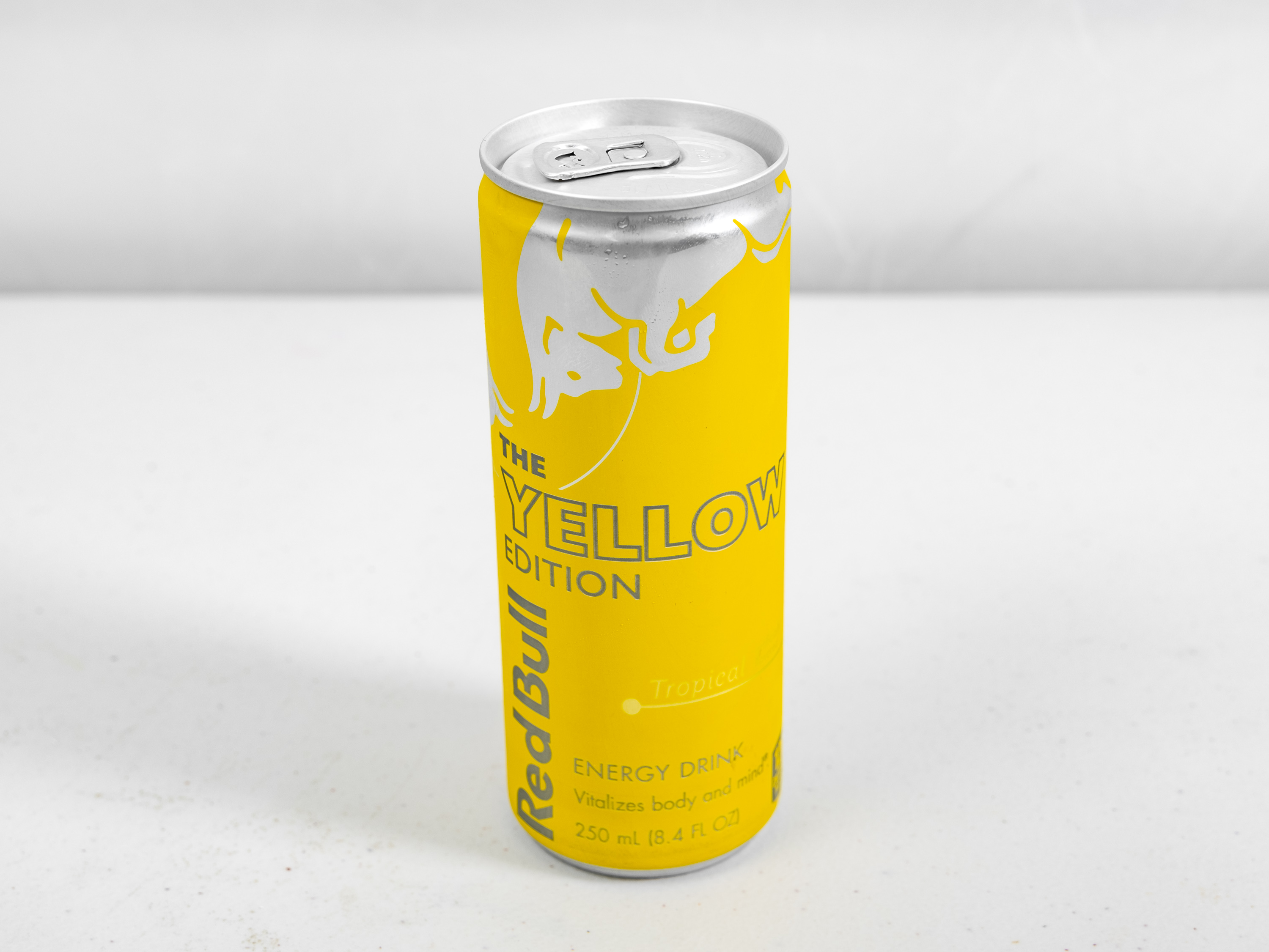 Order Red Bull Yellow Edition, Tropical 12oz food online from Circle K And Liquors store, Fontana on bringmethat.com