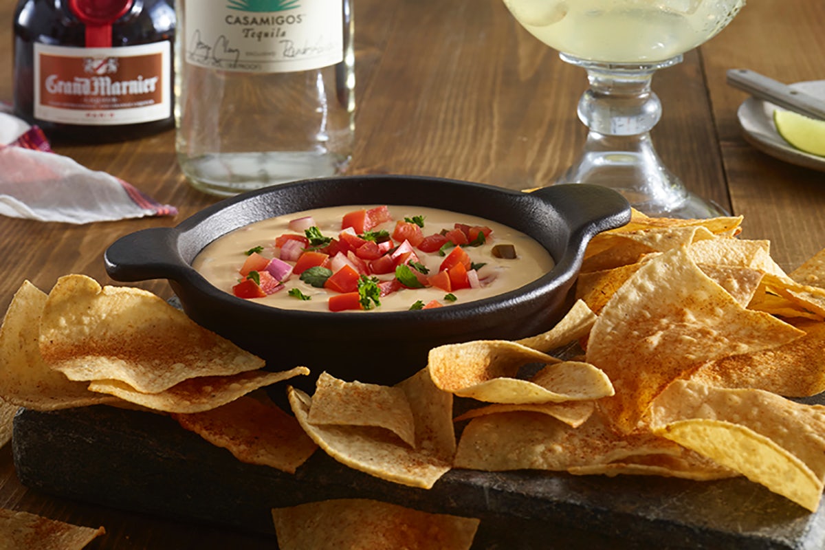 Order Cheddar Cheese Queso & Chips food online from Ruby Tuesday store, Thomasville on bringmethat.com