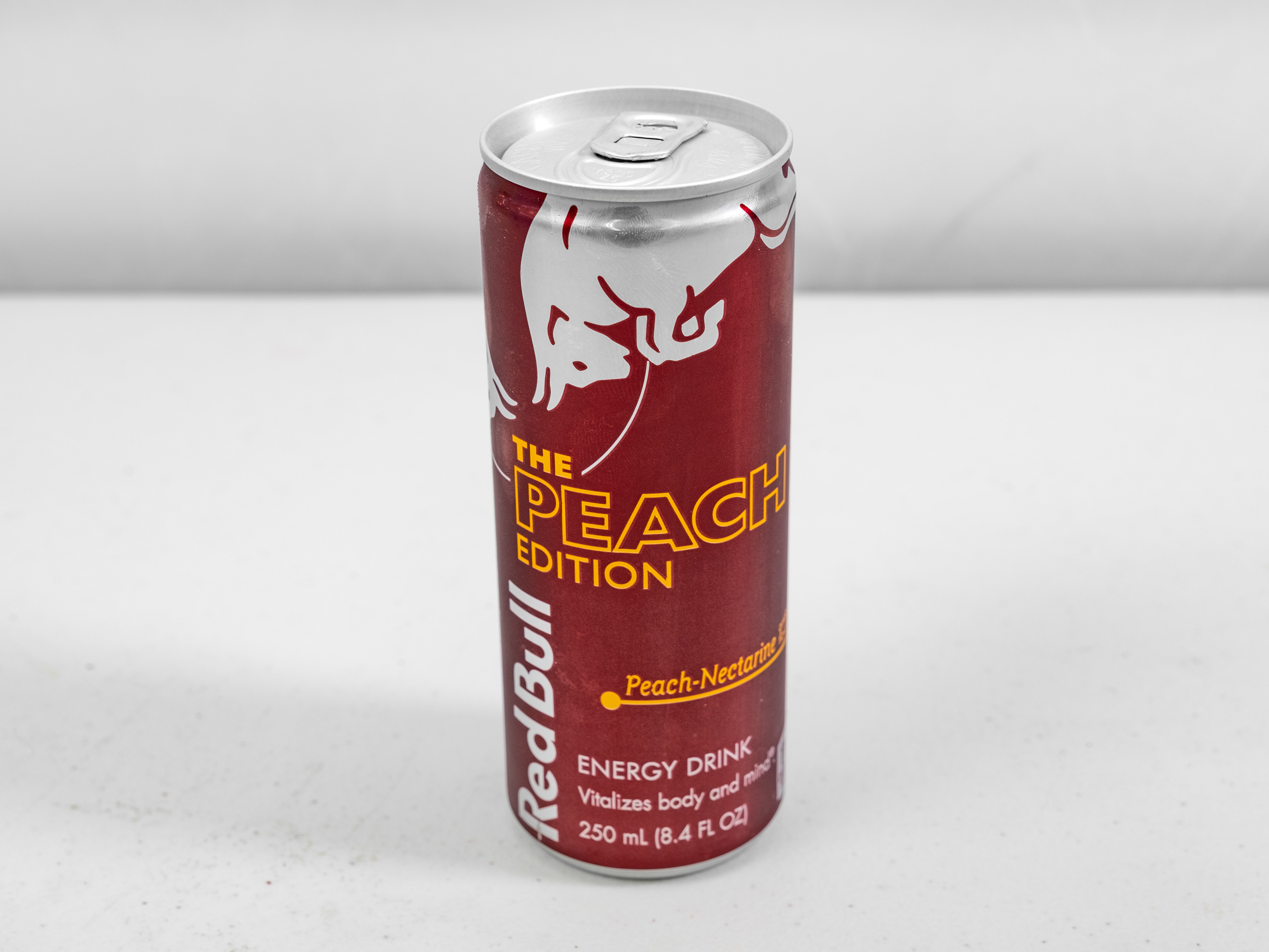 Order Red Bull Peach Edition 12oz food online from Circle K And Liquors store, Fontana on bringmethat.com