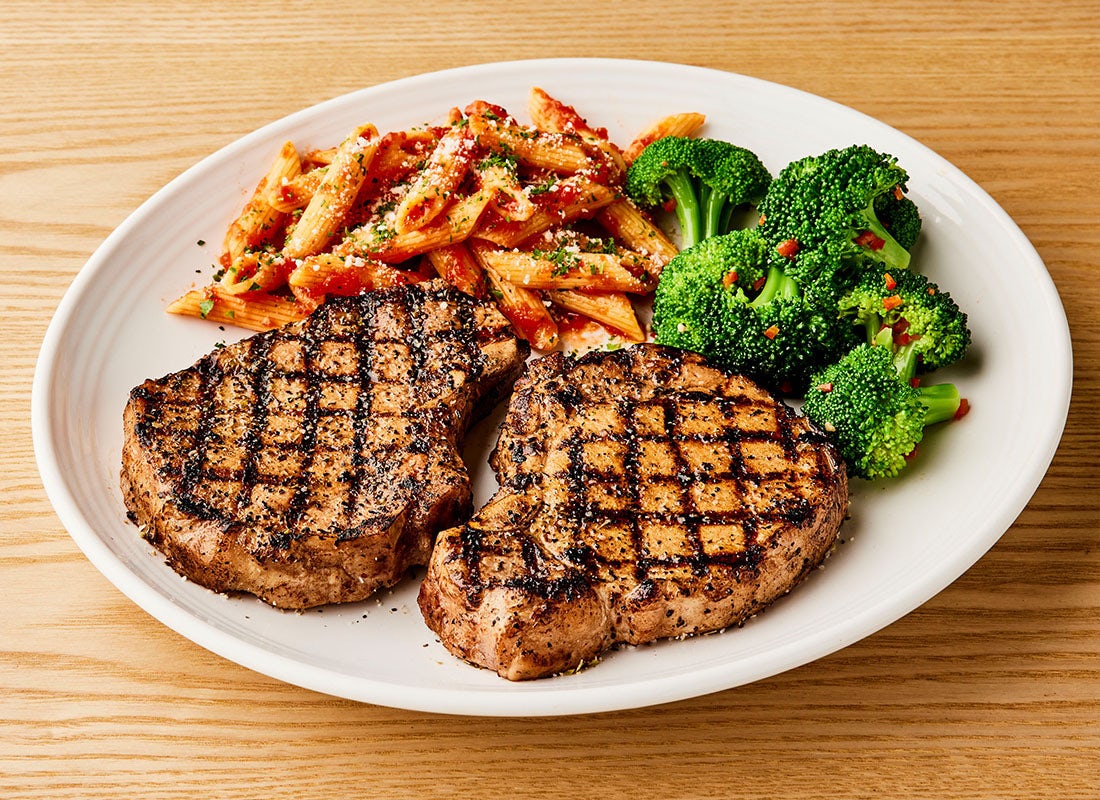 Order Tuscan-Grilled Pork Chop* - Two Chops food online from Carrabba's Italian Grill store, Murrells Inlet on bringmethat.com