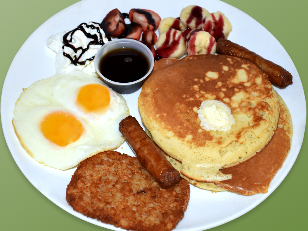 Order Pancakes con huevos fritos, salchicha, hash brown y fruta food online from Cositas Ricas Corp store, Queens on bringmethat.com