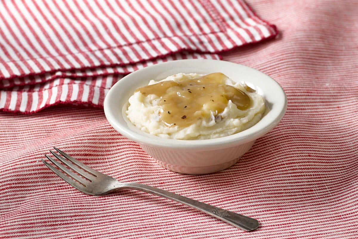 Order Mashed Potatoes with Brown Gravy food online from Cracker Barrel store, Rochester on bringmethat.com