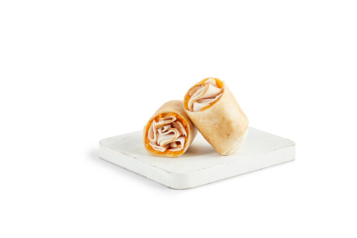 Order TURKEY & CHEDDAR WRAP food online from Tropical Smoothie Cafe store, Bay Shore on bringmethat.com